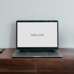 An image of laptop displaying "Hello World" message